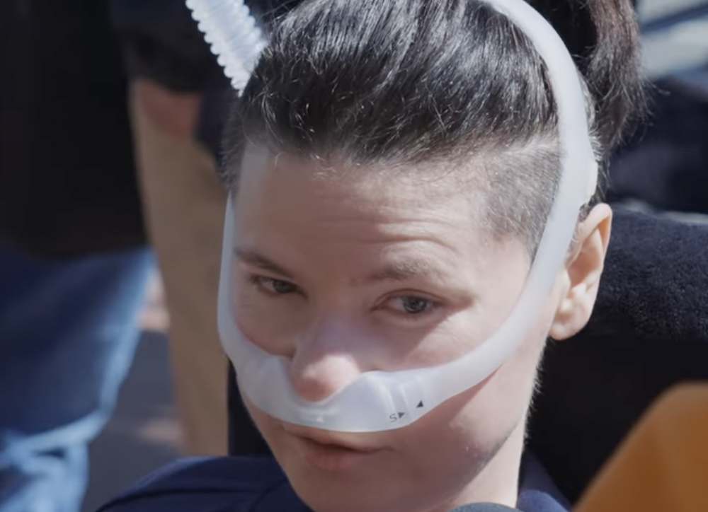 NIepełnosprawna osoba podczas pikiety fundacji Avelon przed budynkiem KPRM